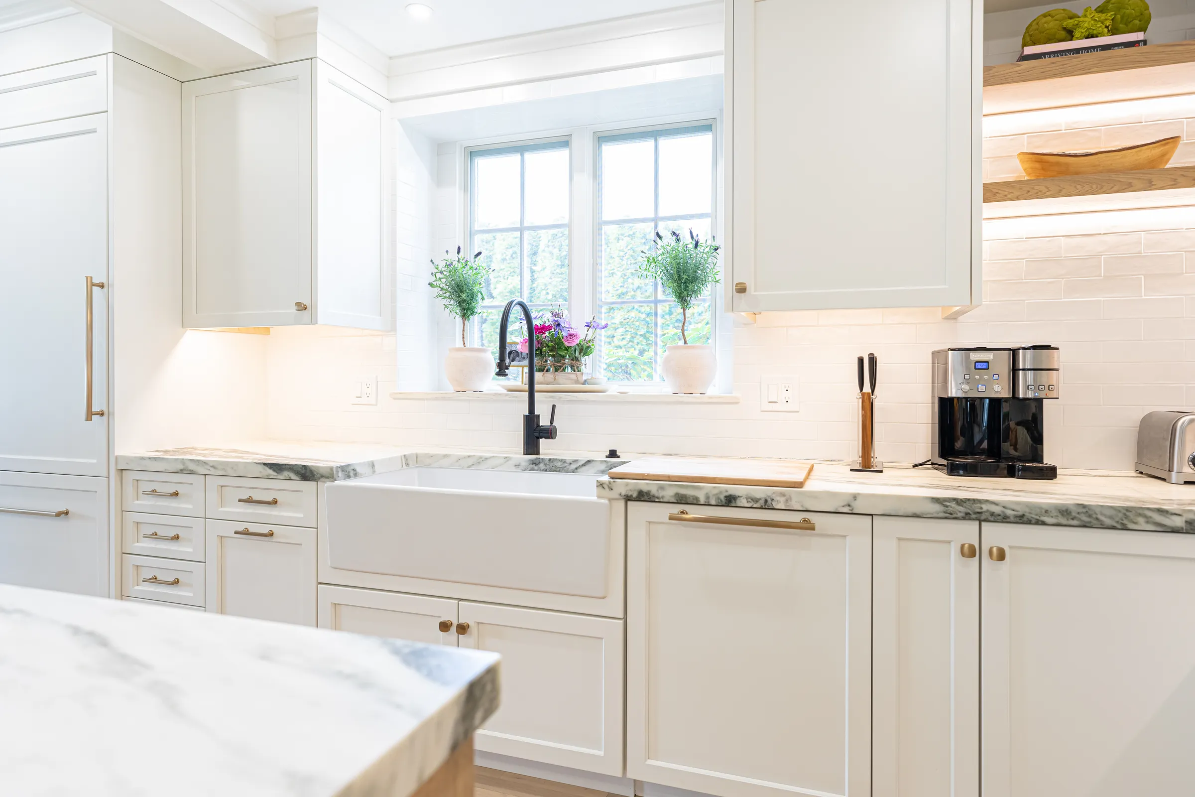 Mitred quartzite edge meeting a farmhouse sink
